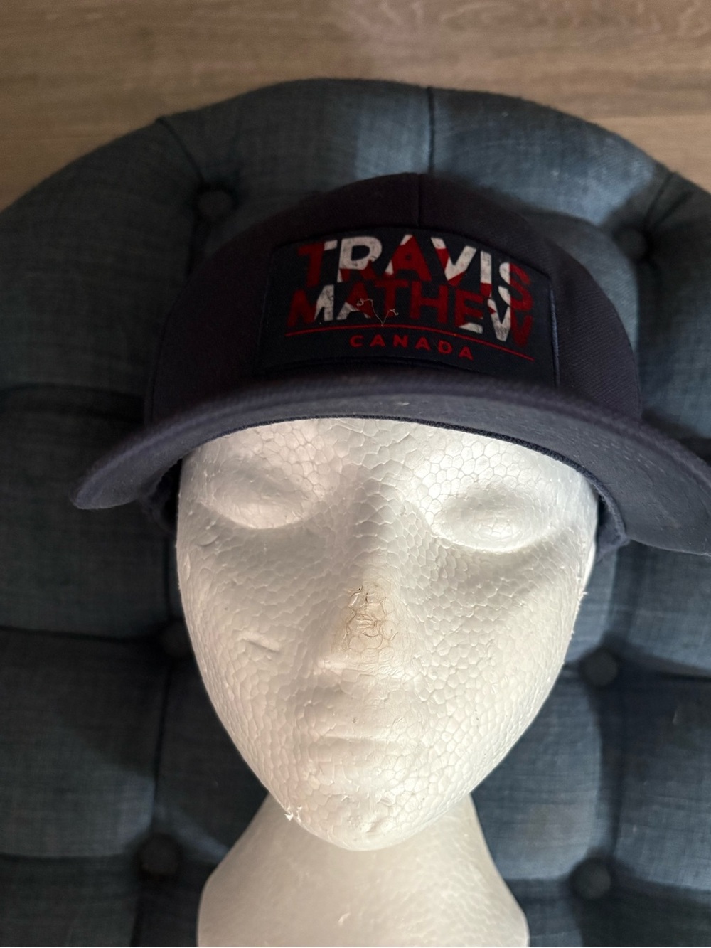 Travis Mathew Navy Hat with Red Logo Patch